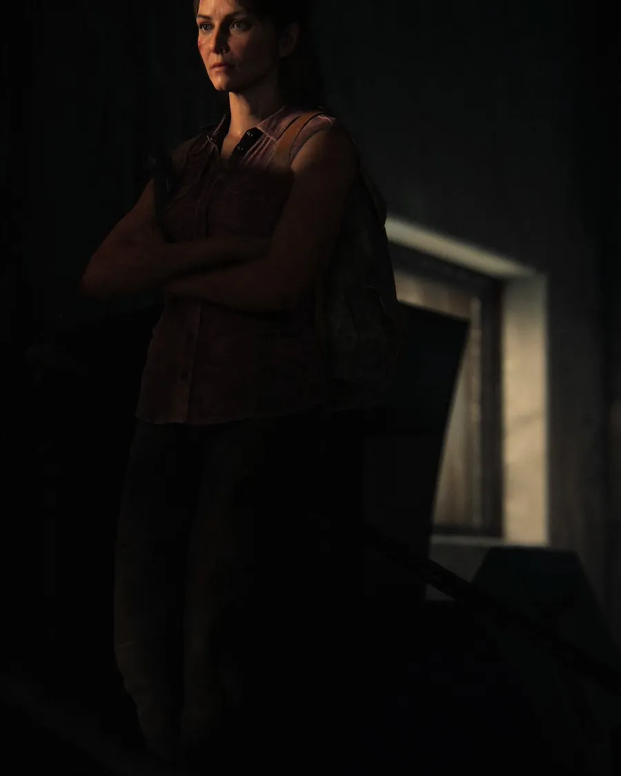 Tess Servopoulos standing with folded arms in an official The Last of Us Part I Photo Mode portrait