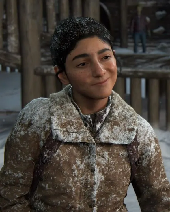 Dina wearing a snow-covered jacket in an in-game scene from The Last of Us Part II