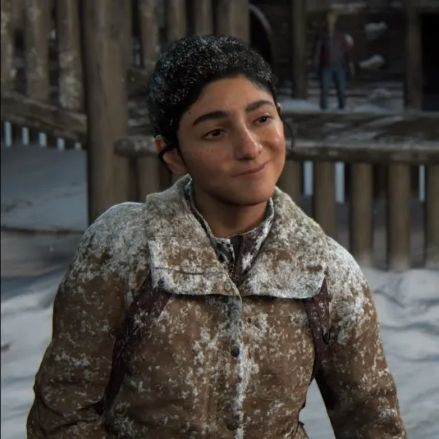 Dina wearing a snow-covered jacket in an in-game scene from The Last of Us Part II