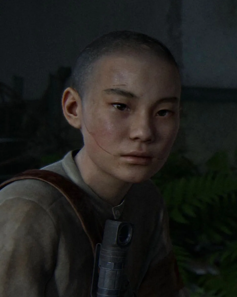 Lev looking toward the camera in overgrown ruins in The Last of Us Part II